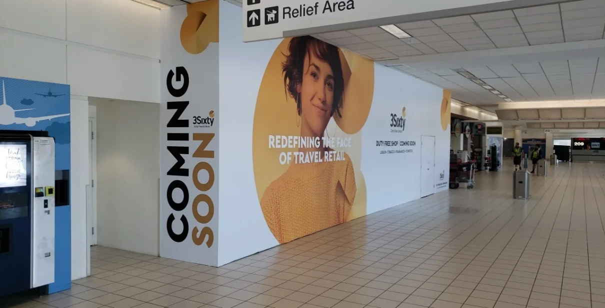 Printed construction barricade graphics wrapping a jobsite perimeter at a retail build