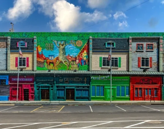 Building-scale exterior graphic on the Color Reflections building in Philadelphia, reproducing the historic Spring Garden Street storefronts in Northern Liberties